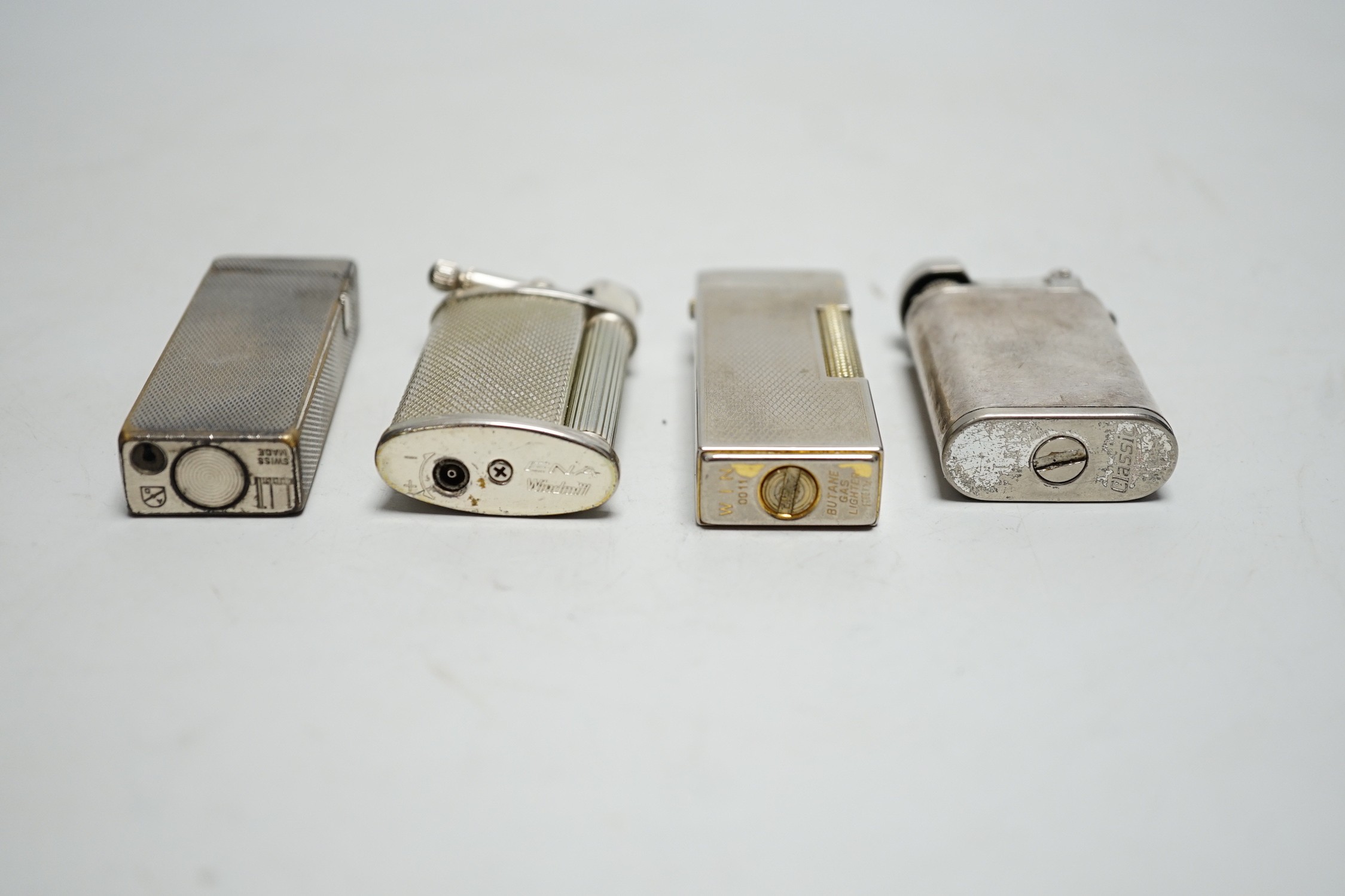 A Dunhill Rollegas lighter and four others
